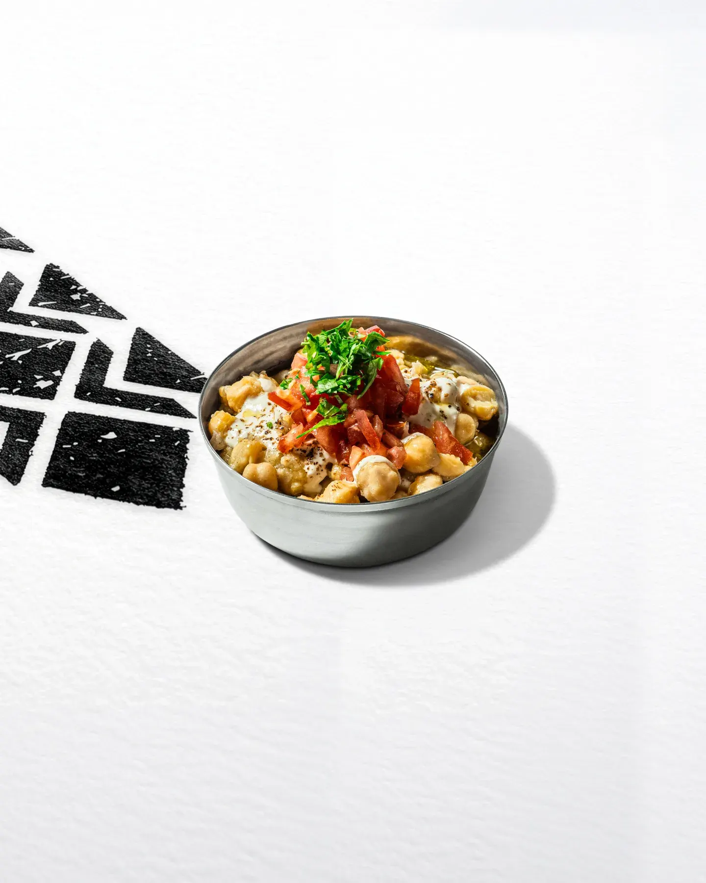 A bowl of chickpea fatteh with its garnish.