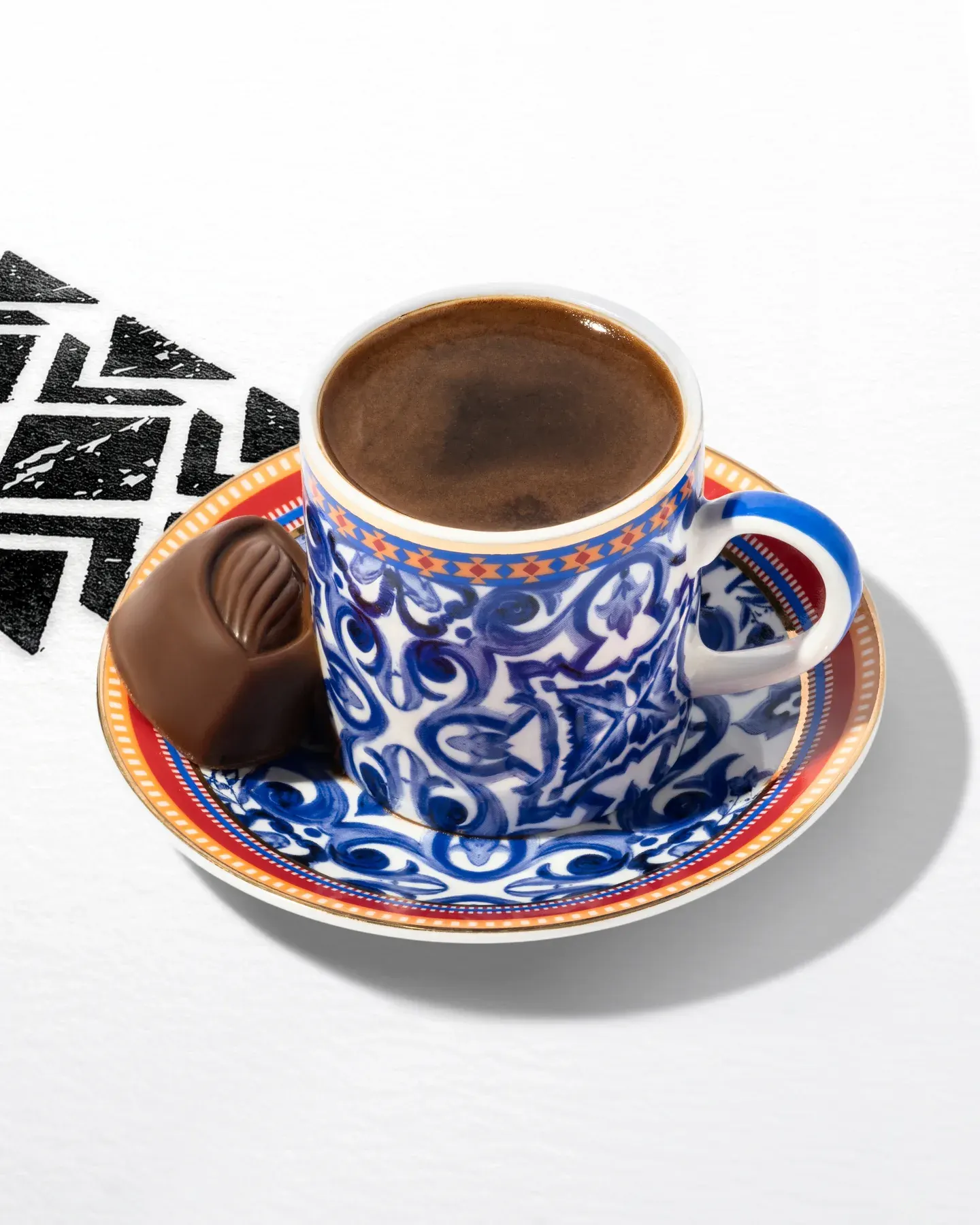 Arabic coffee in a blue patterned cup and saucer.