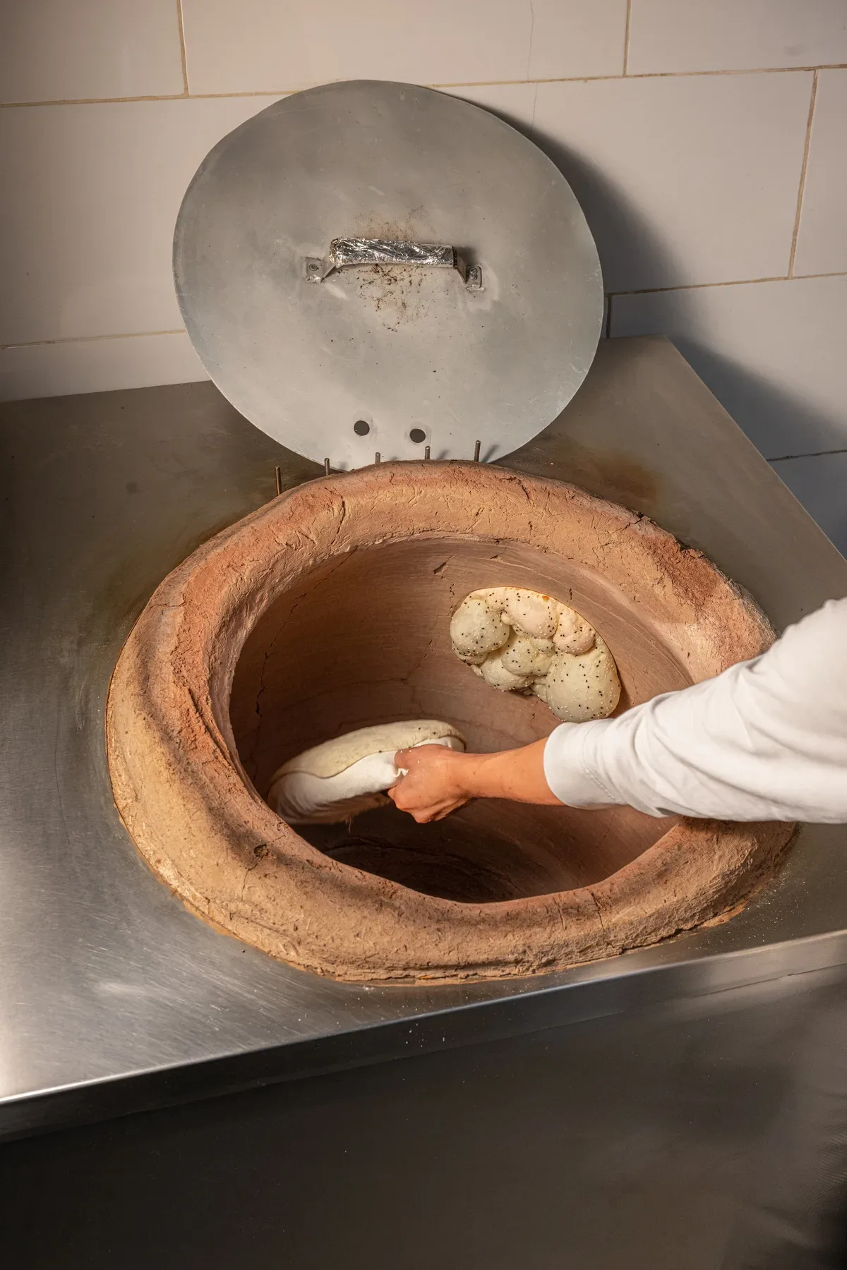 Dough placed by hand into the clay oven.