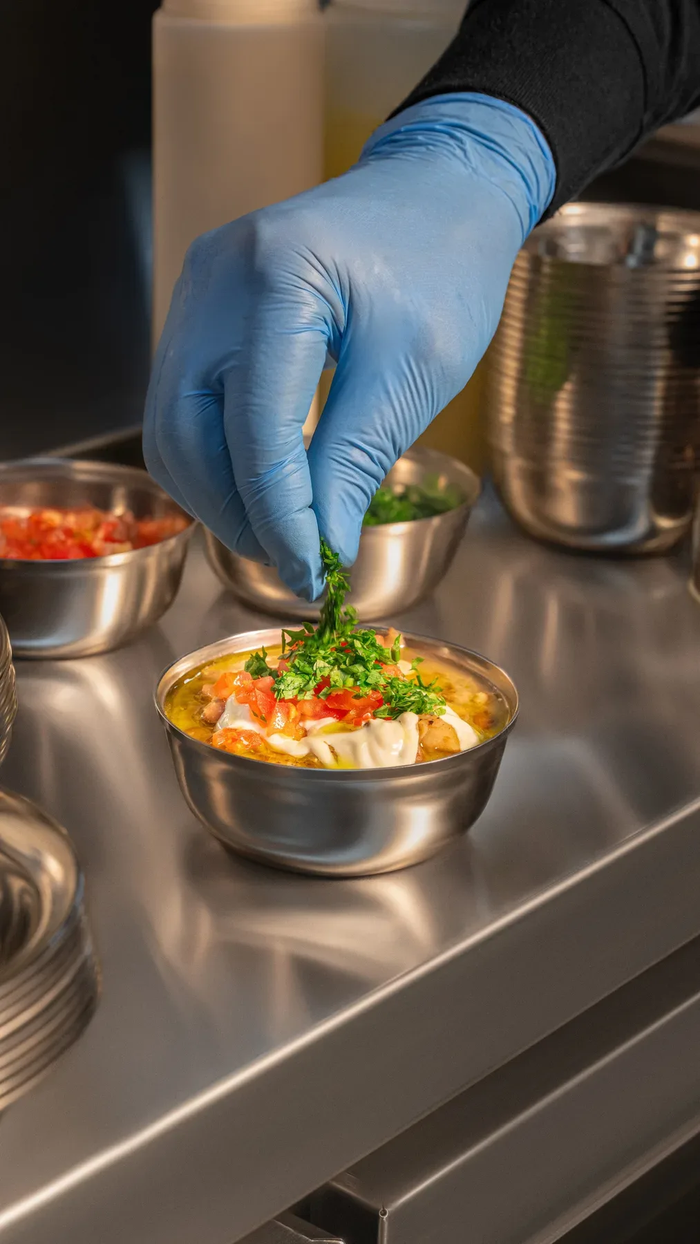 A bowl garnished on the pass, the cover frame for the kitchen reel.