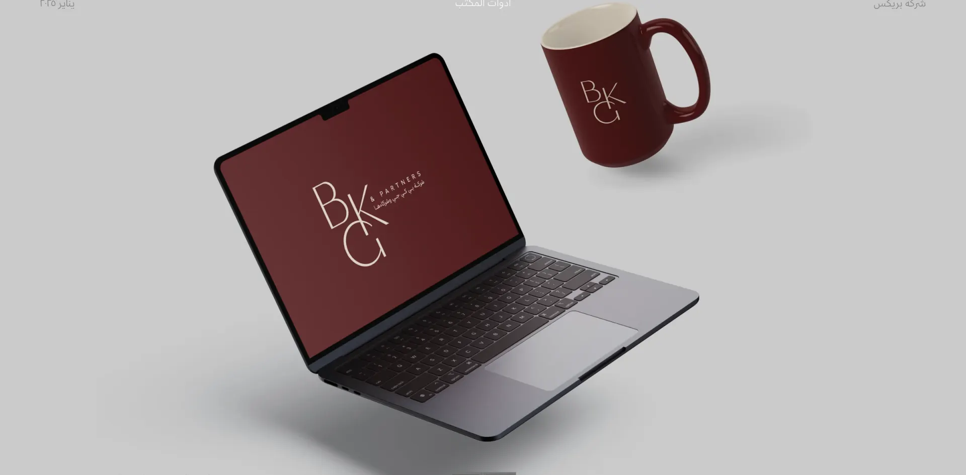 BKG & Partners identity on a laptop and mug