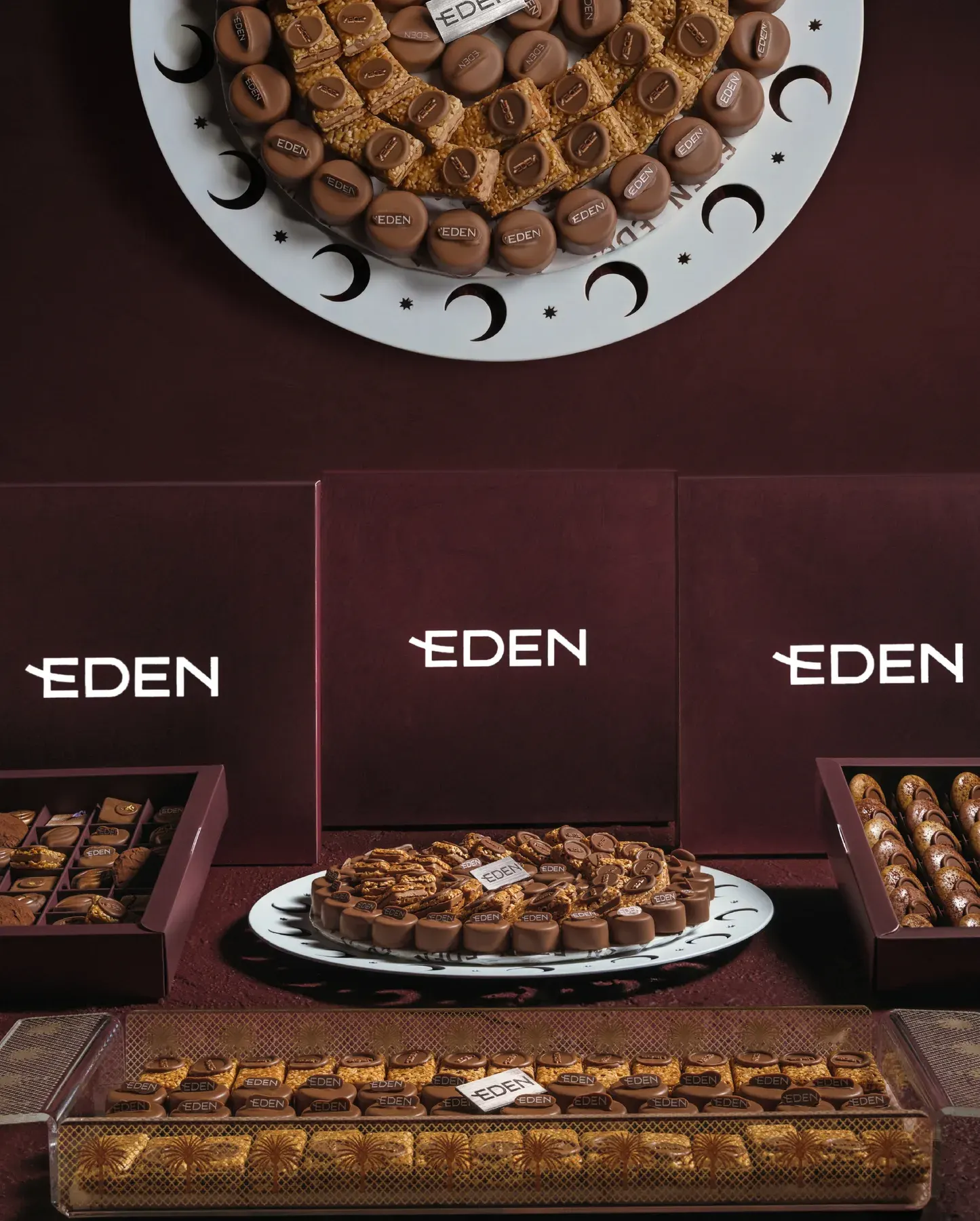 A platter edged with crescent moons, set among Eden boxes and trays.