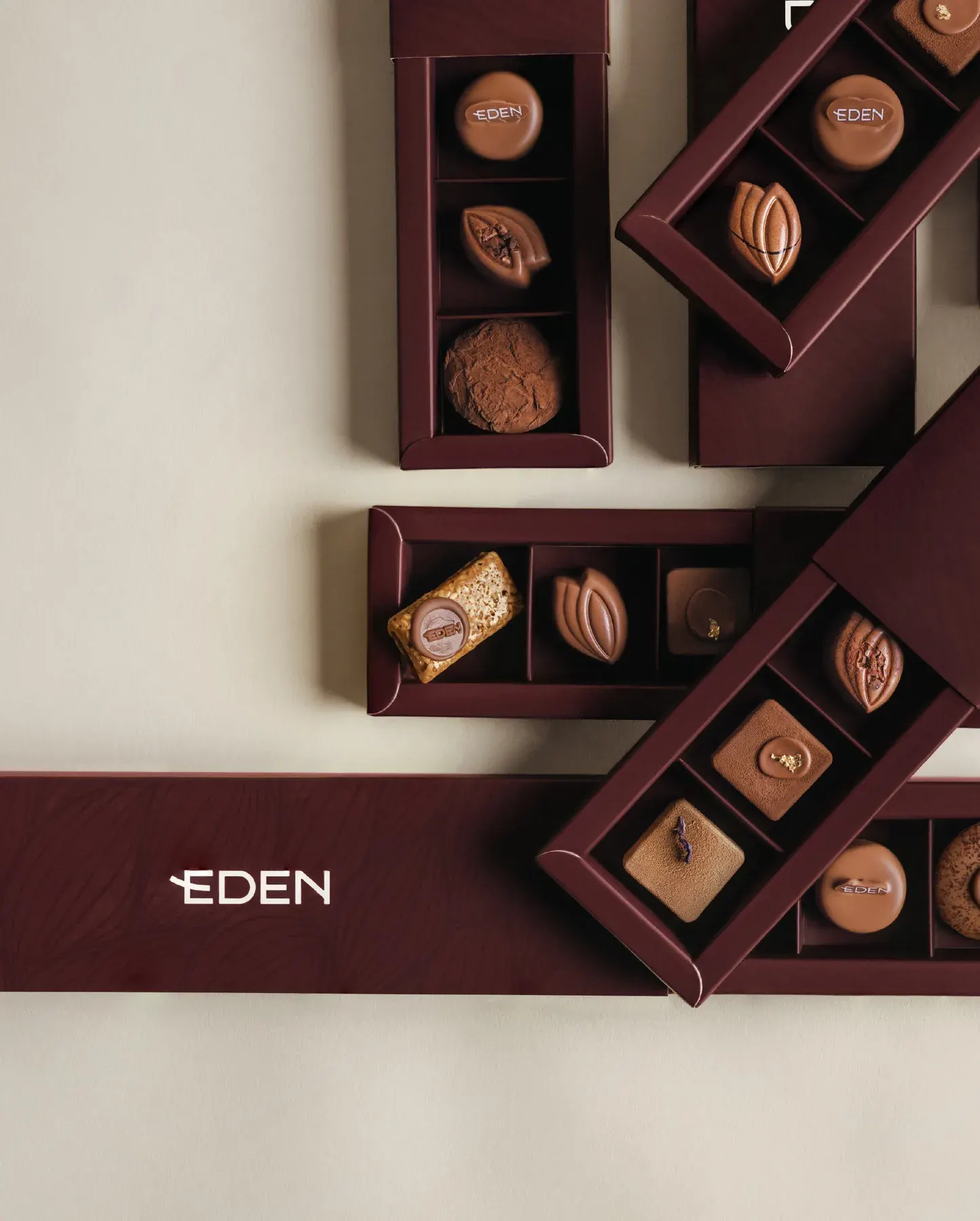 Slim Eden boxes open in a flat lay, each holding a different assortment.