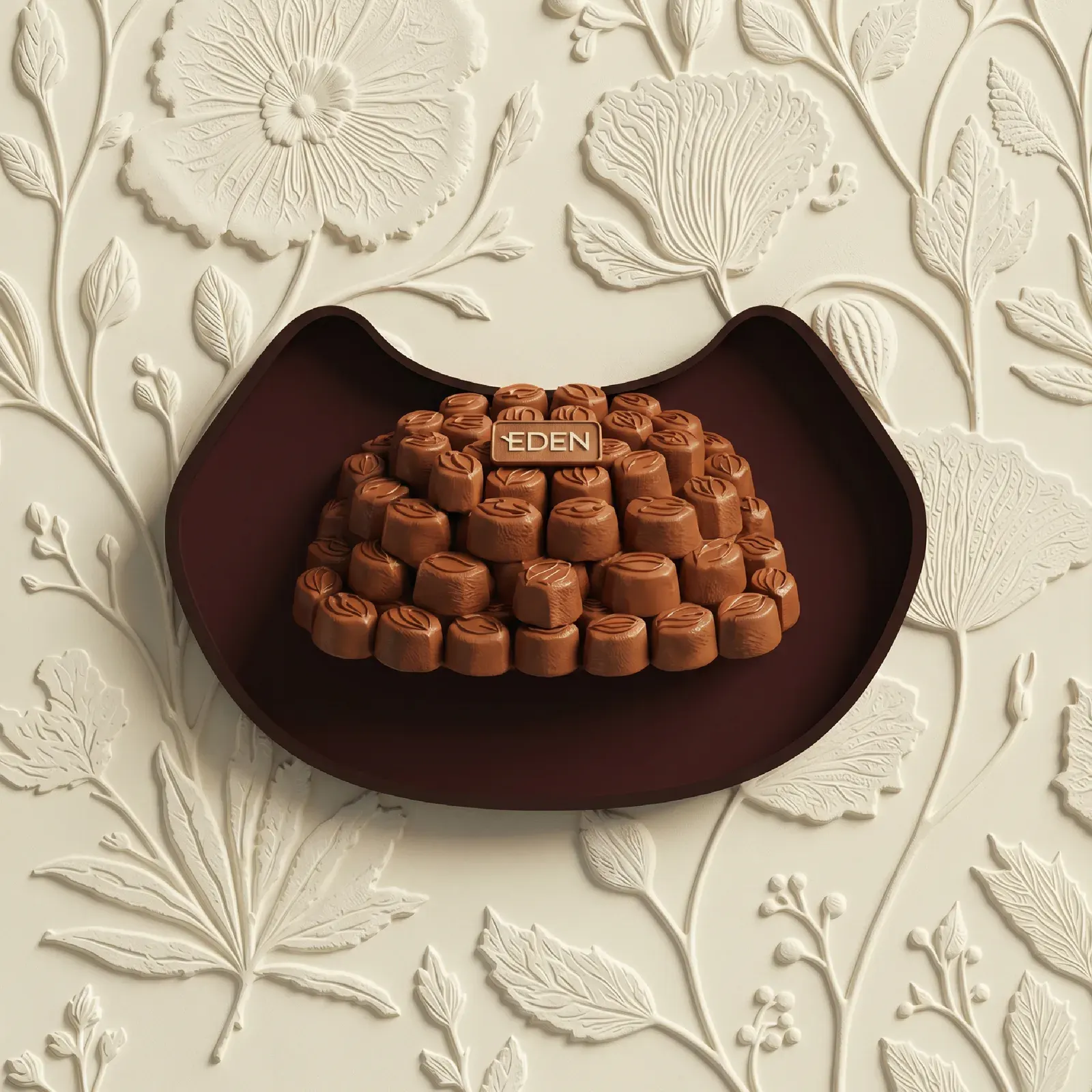 Highlight cover for trays, a crescent dish of chocolates on the floral relief.