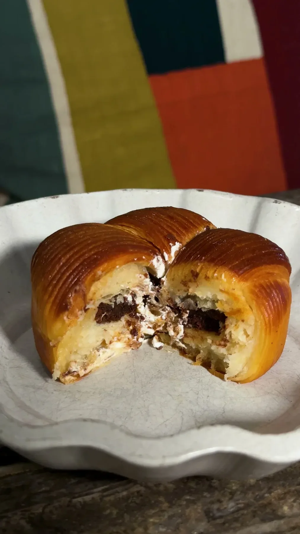 A laminated pastry cut open to show its chocolate and cream filling.