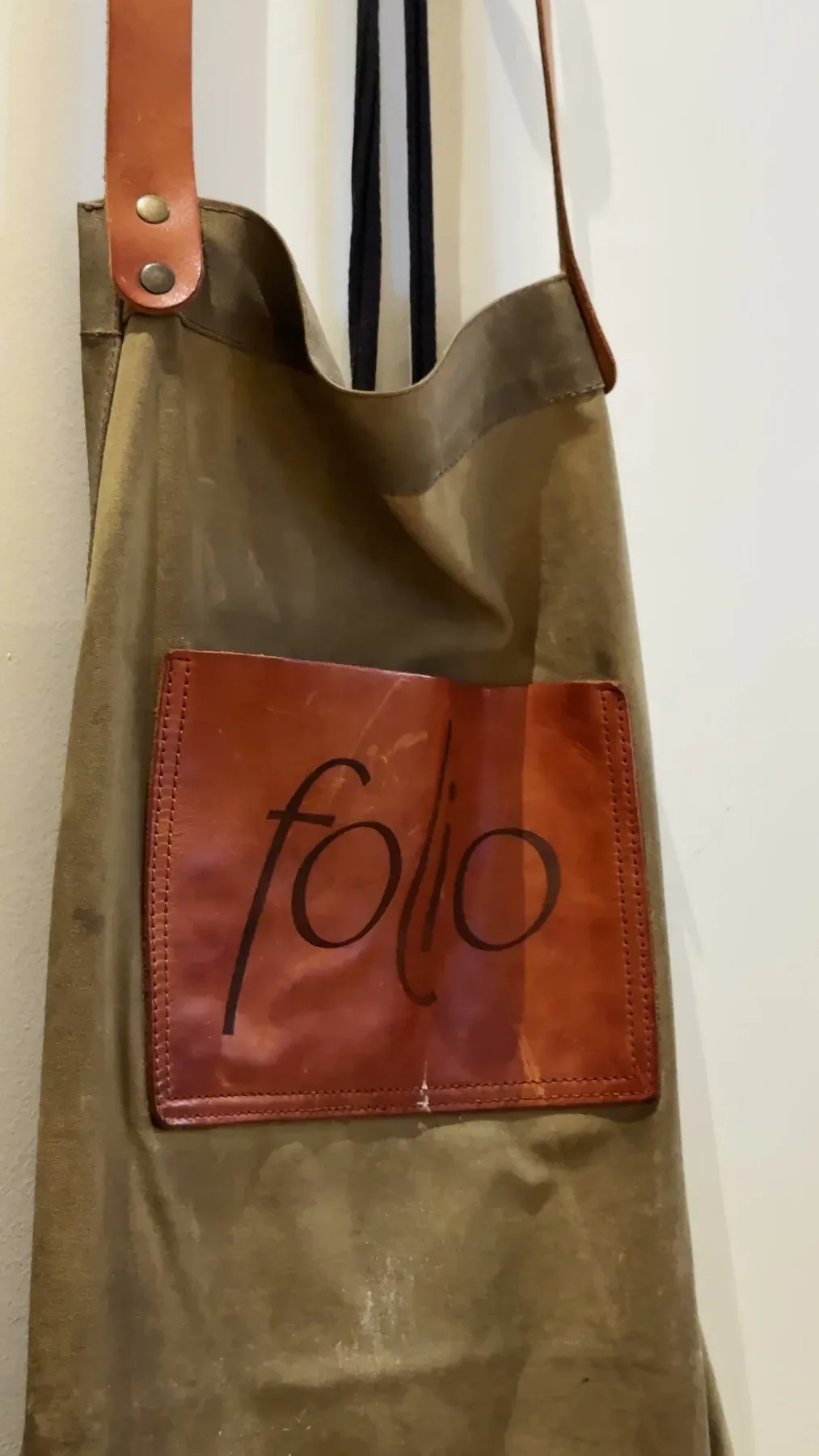 A waxed canvas Folio apron with a stitched leather pocket.