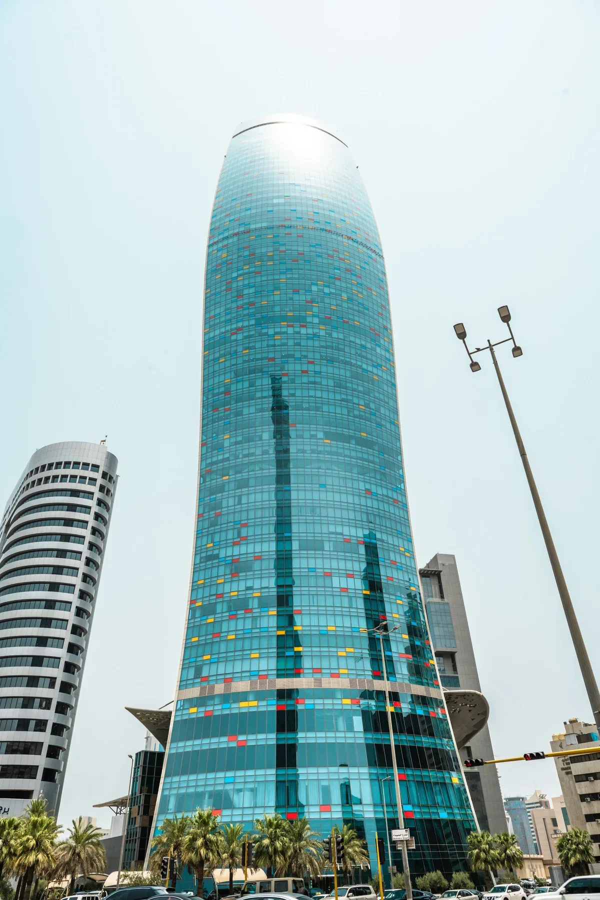 KIPCO Tower from the street, with the coloured panels that band its glass.
