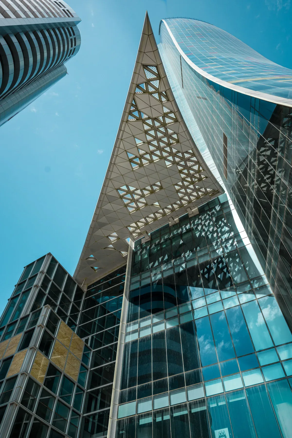 The pointed glass prow and its perforated screens, from the plaza.
