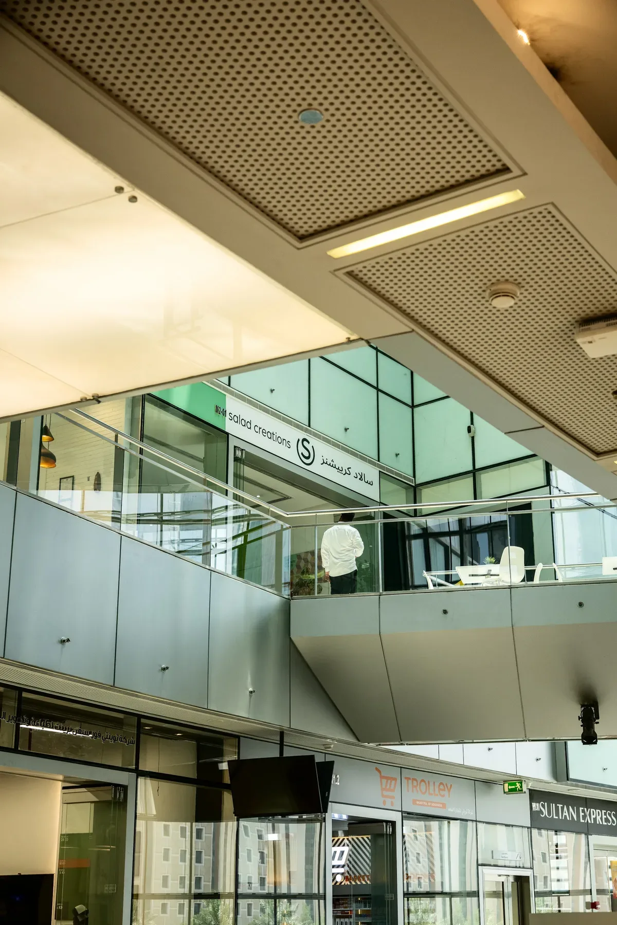 Upper balconies and glass fronts inside the building.