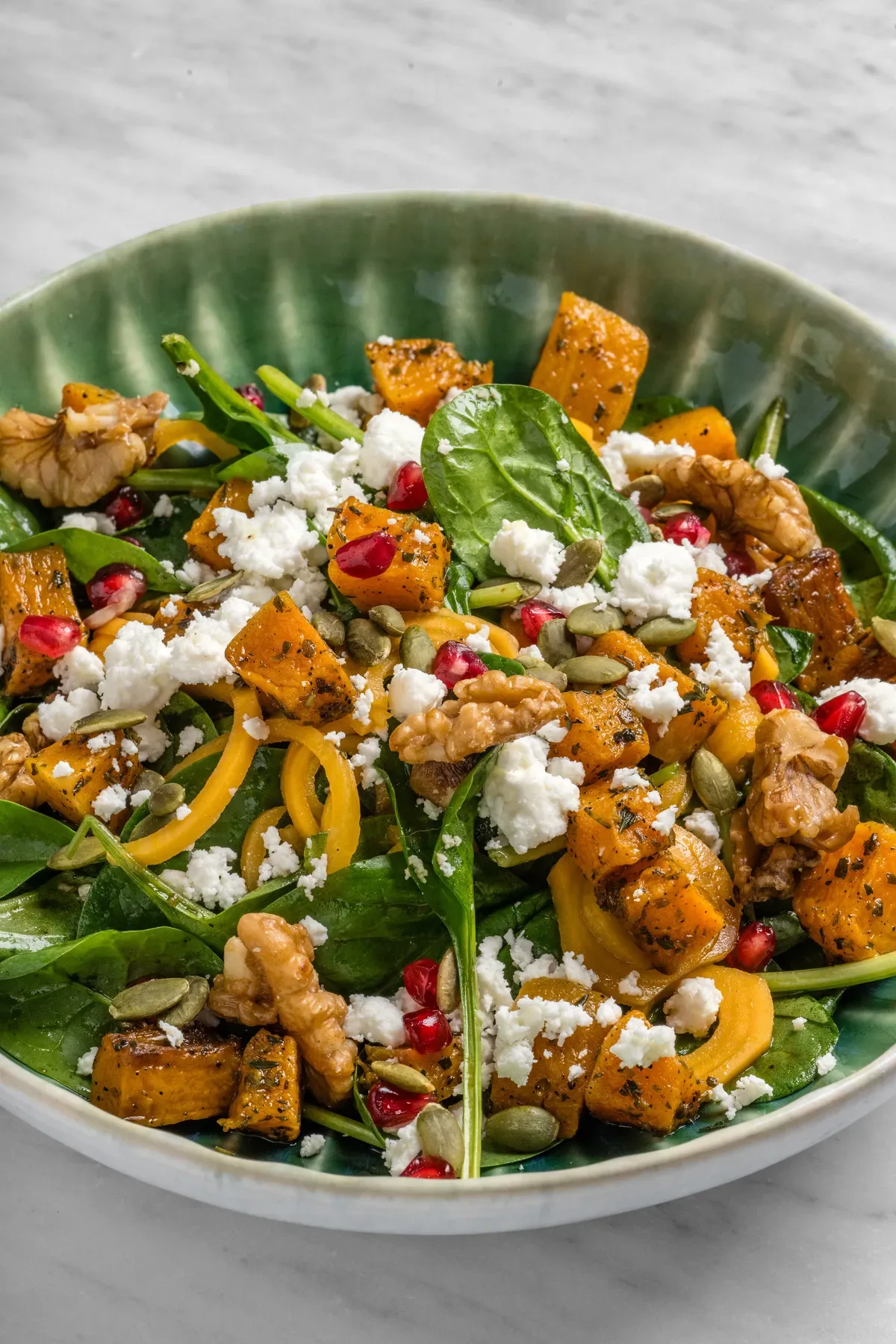 A roast squash and feta salad, overhead.