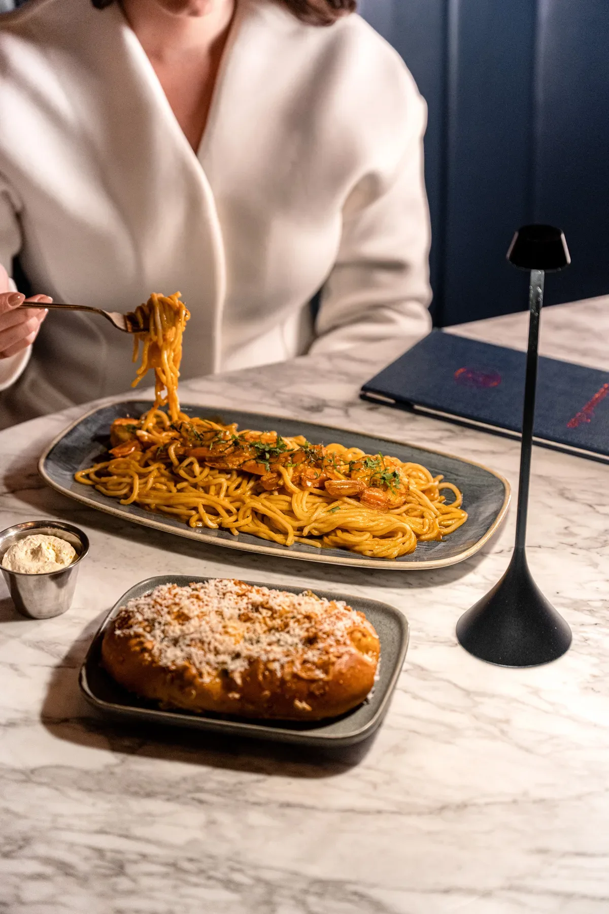 A cheese pull from a dish of baked pasta.