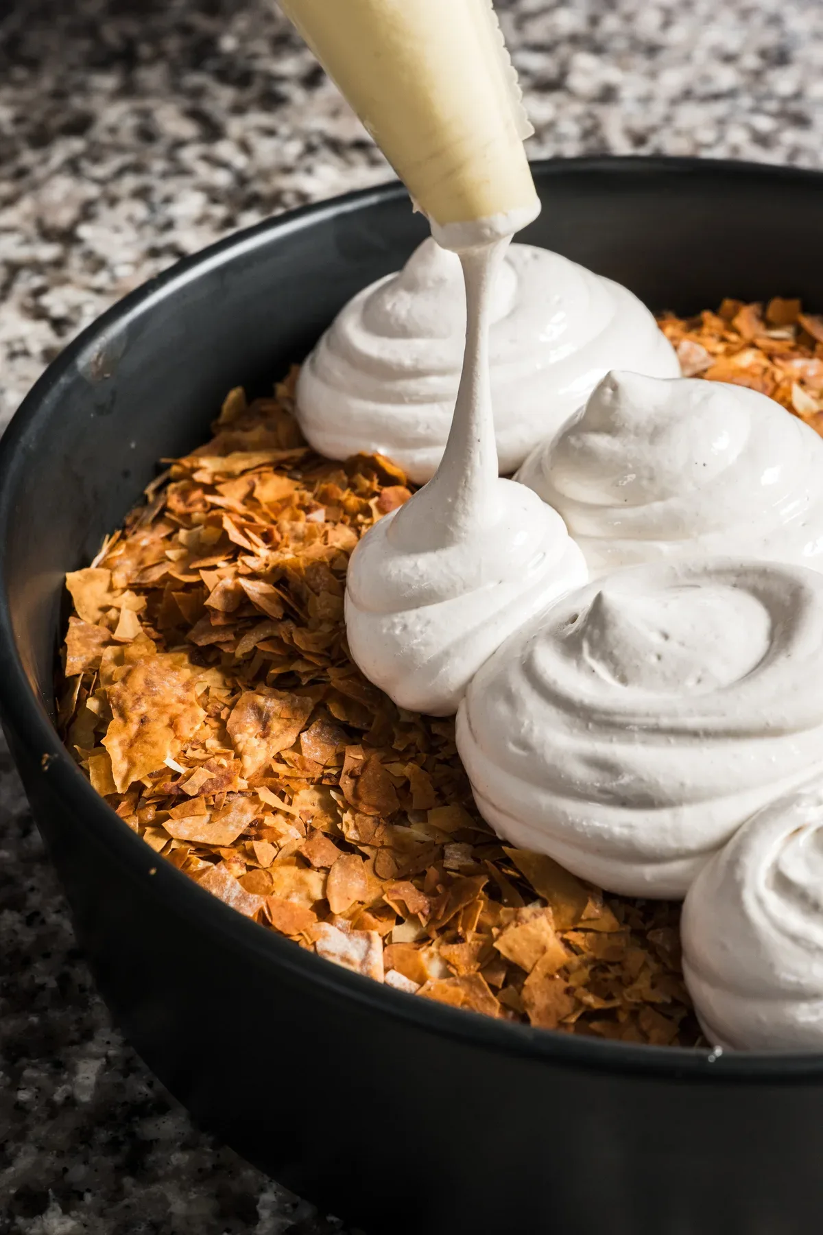Meringue piped onto the Ramadan cake in the kitchen.