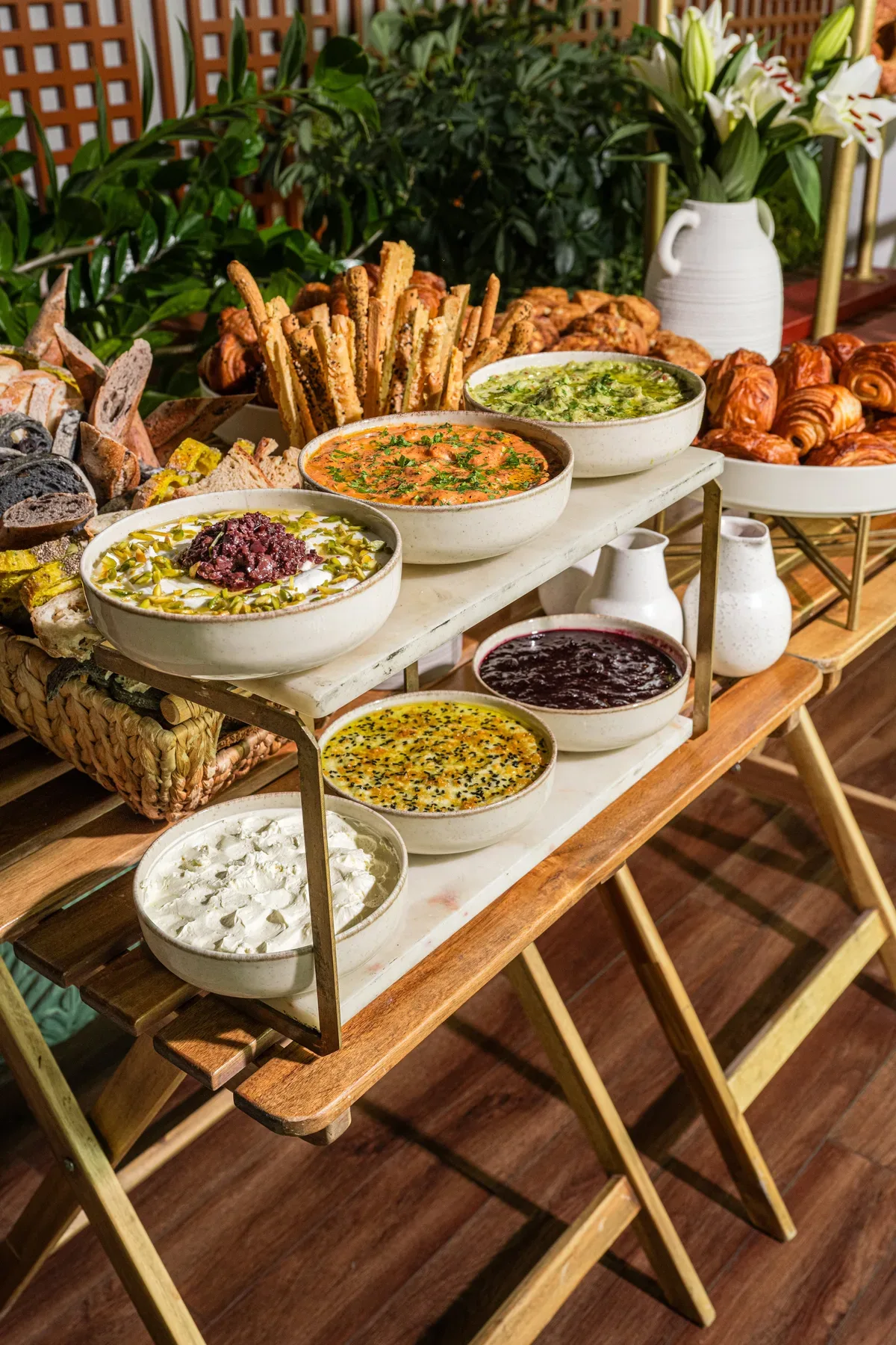 A mezze spread on a wooden trestle table.
