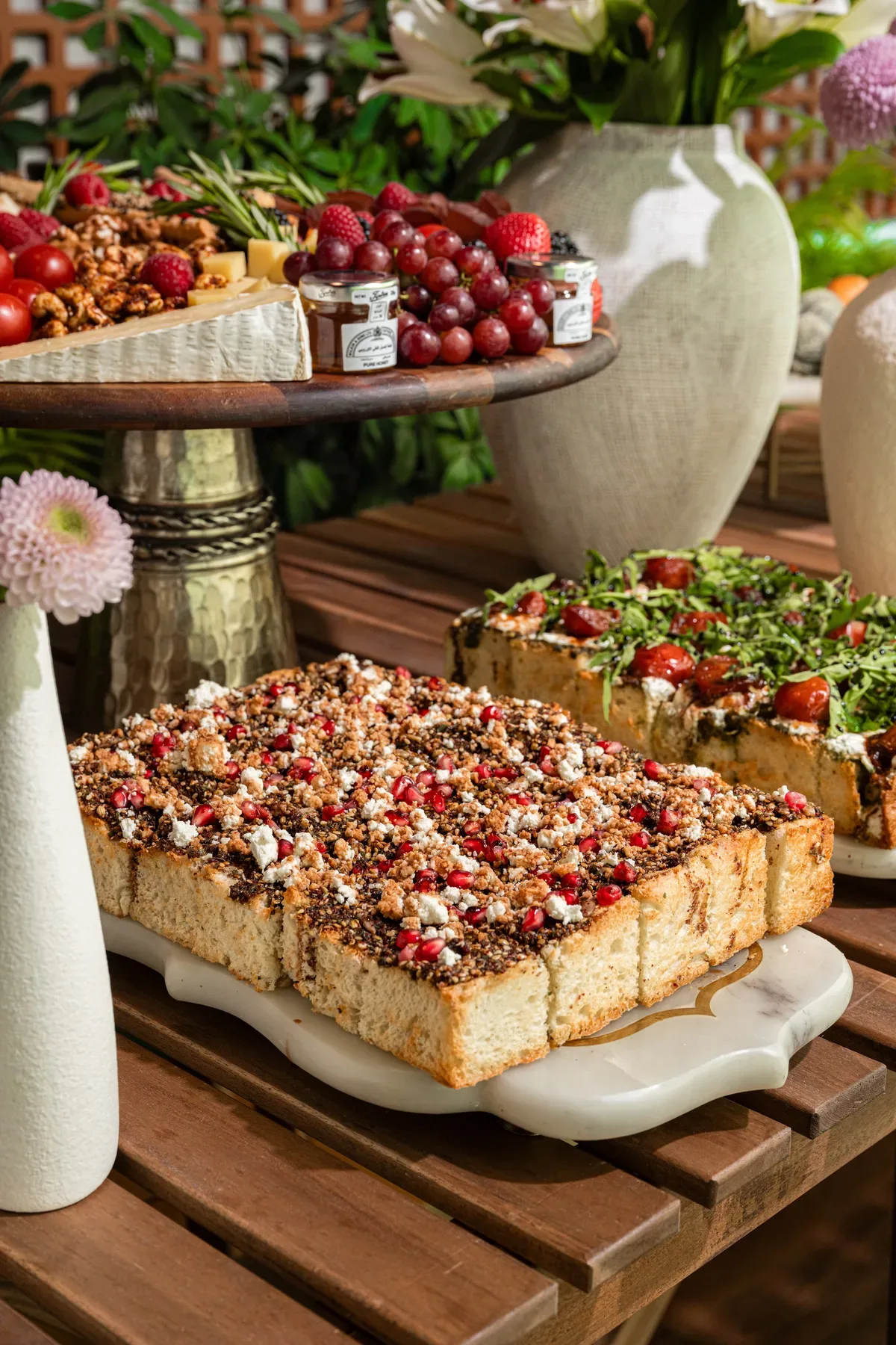 A tomato tart slab with cherries on the catering table.