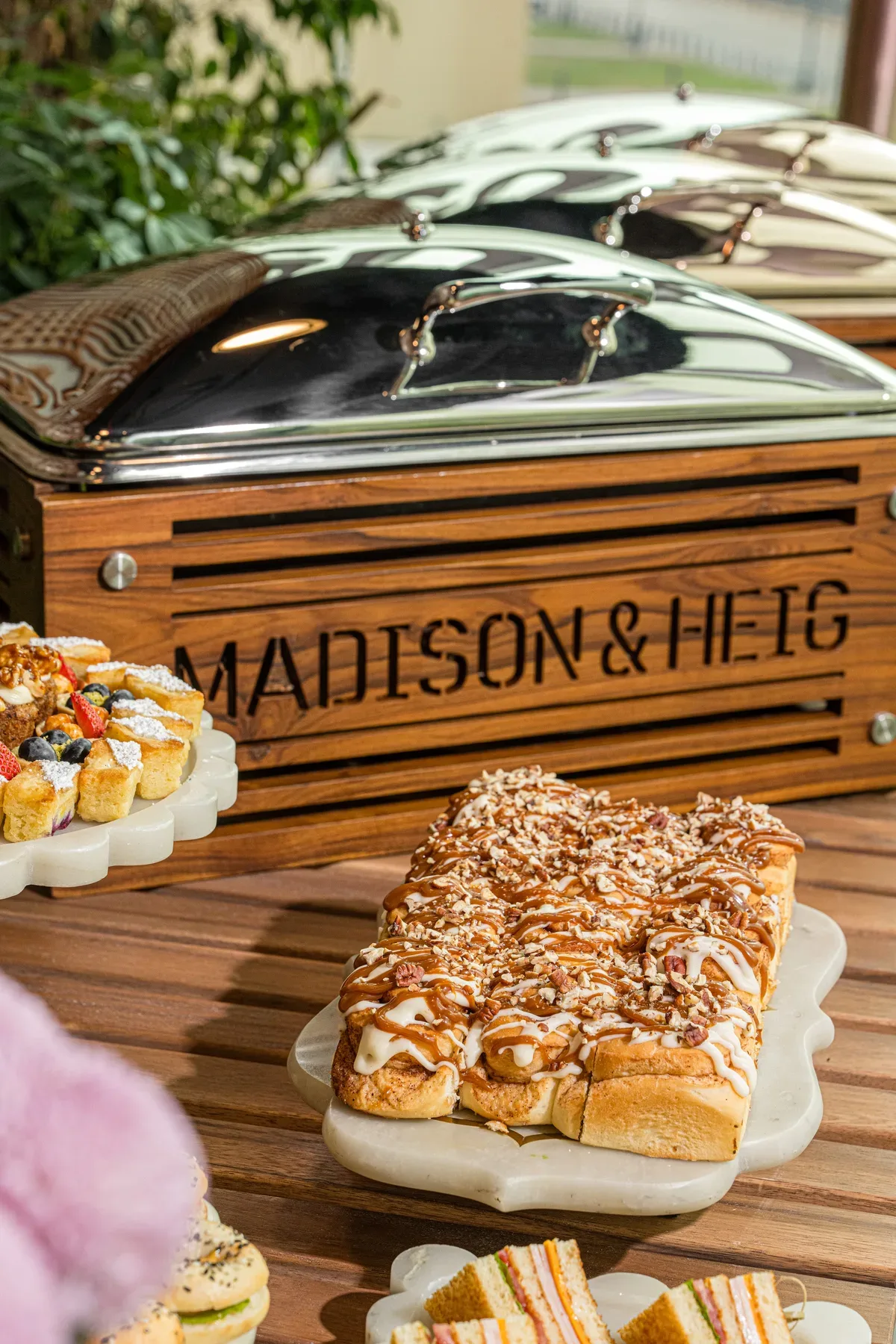 A wooden crate branded Madison & Heig holding a chafing dish.