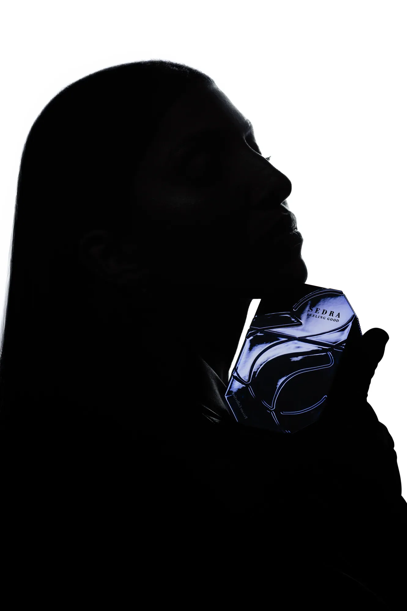 Two frames from the black set. The bottle is held rather than placed, so it stays close to the skin.